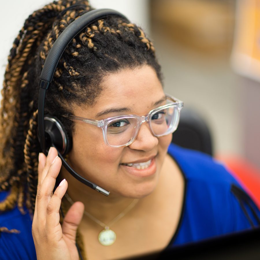 A smiling 211 navigator wearing a headset
