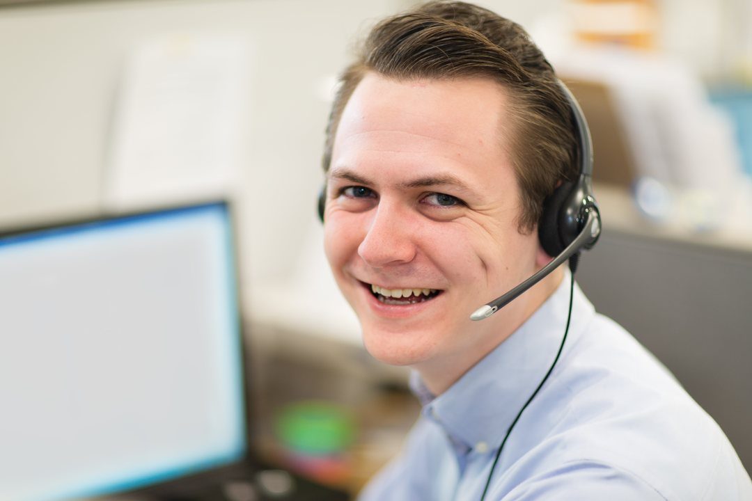 A smiling 211 navigator wearing a headset